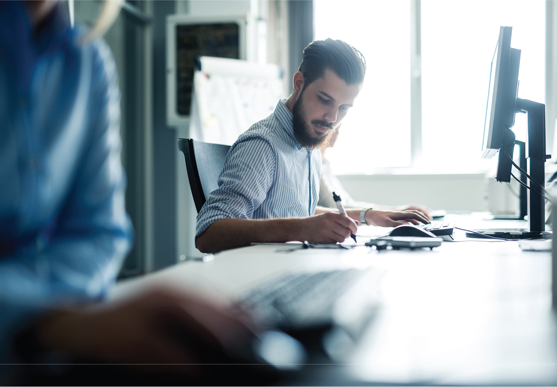 Professional reviewing documents at a desk